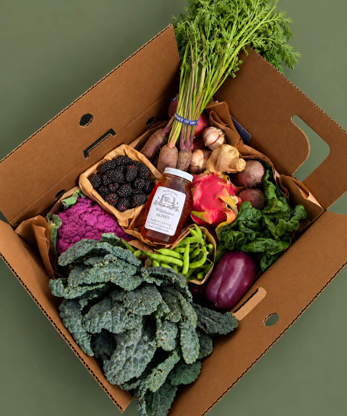 Overhead view of The Sexy Chef Box by Courtney Trop of @alwaysjudging, a Market Mama box of dino kale, purple produce, blackberries and local honey delivered in Los Angeles