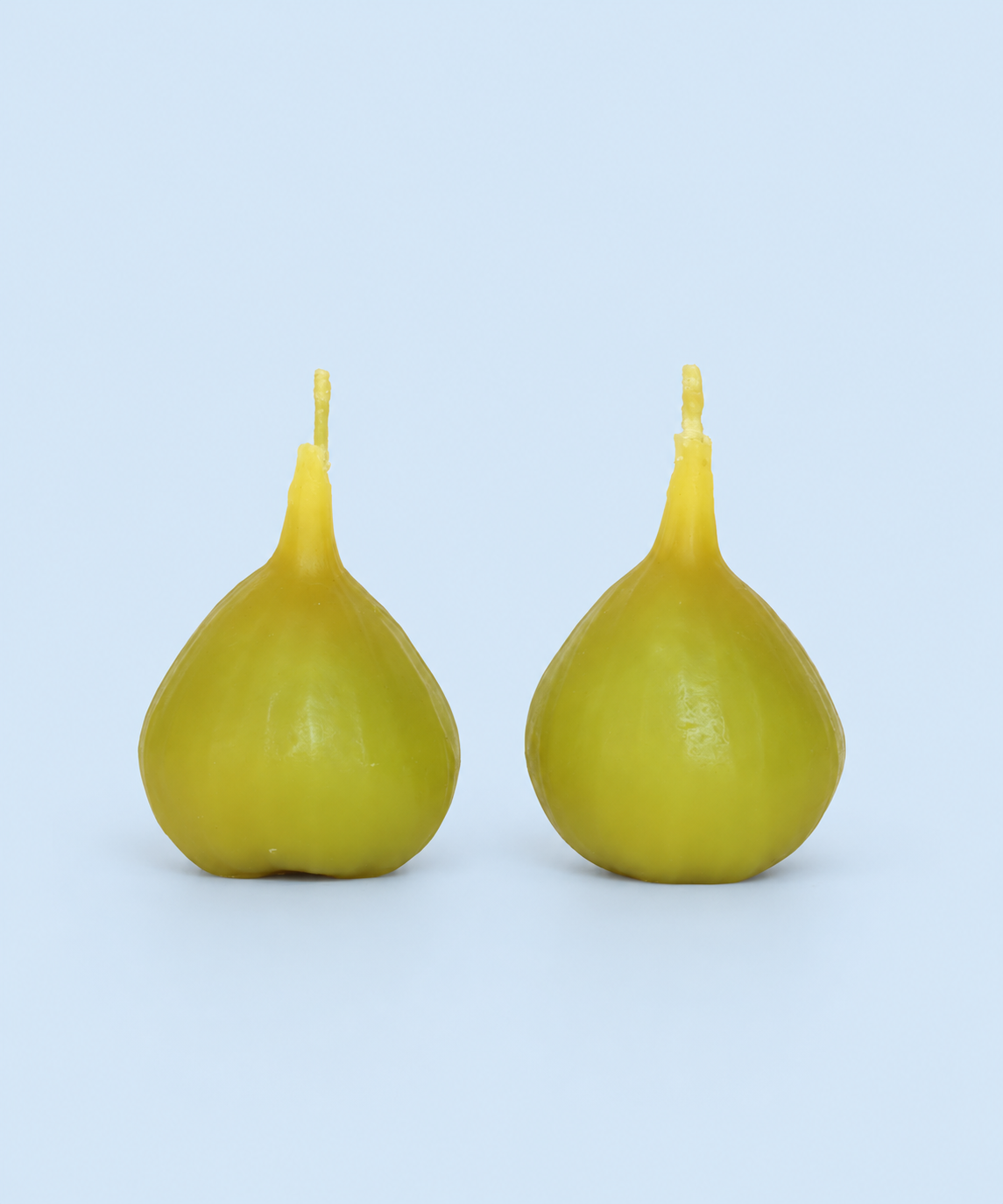 Soft green fig-shaped beeswax candle, handmade in Los Angeles