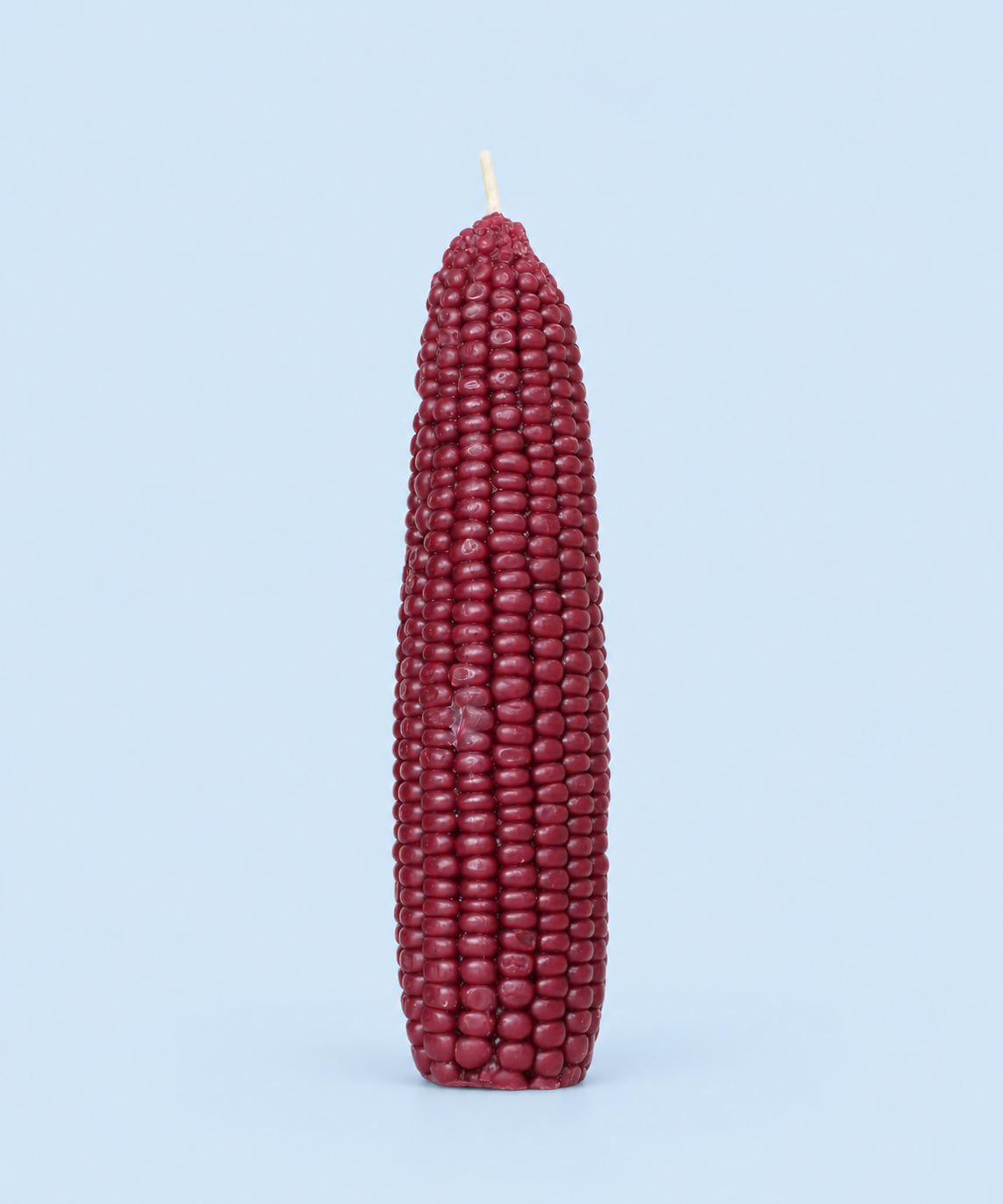 Deep mulberry-red corn cob beeswax candle, handmade in Los Angeles