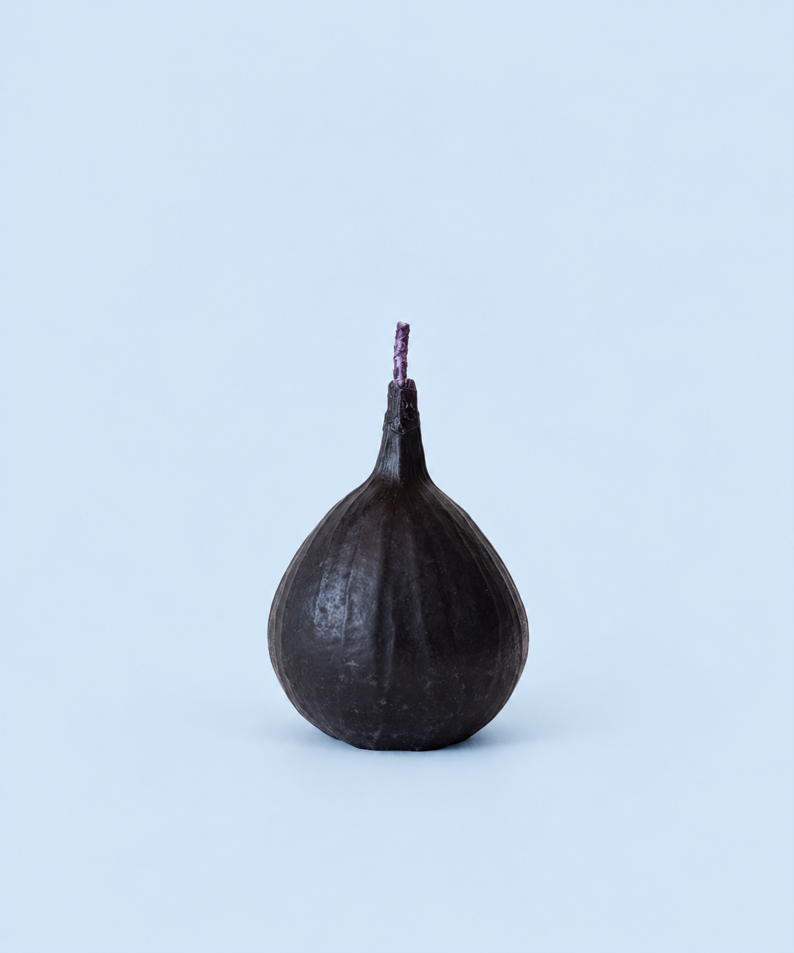 Deep plum purple fig-shaped beeswax candle, handmade in Los Angeles